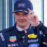 Split-screen graphic showing Max Verstappen in his Red Bull Racing F1 gear on the left, transitioning to his endurance racing suit next to a Verstappen Racing Mercedes-AMG GT3 car at the Nürburgring Nordschleife track on the right.