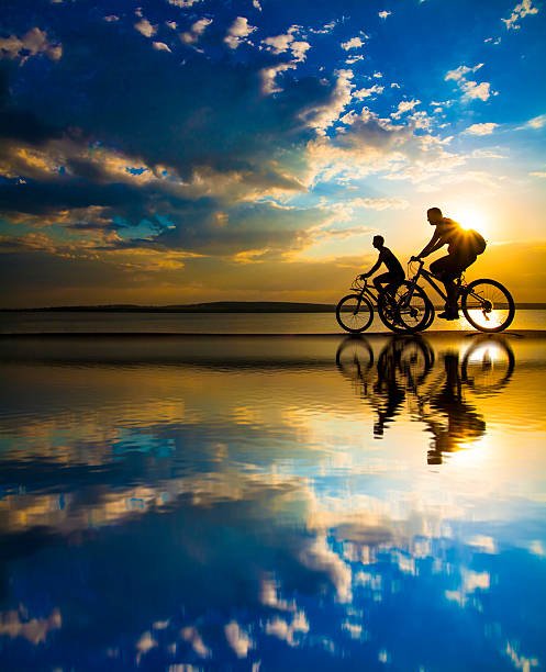 sunset people cycling